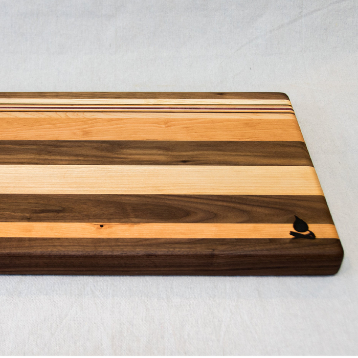 Walnut with stripes of Maple, Cherry and Purple Heart Cutting Board