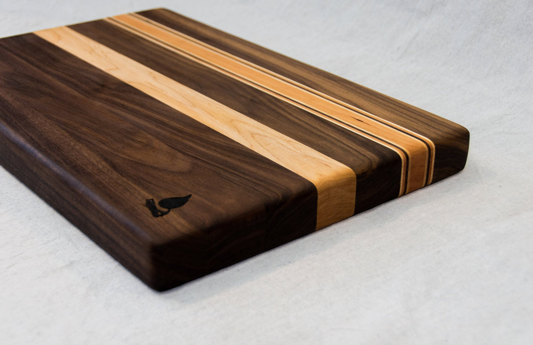 Walnut with stripes of Maple and Cherry Cutting Board