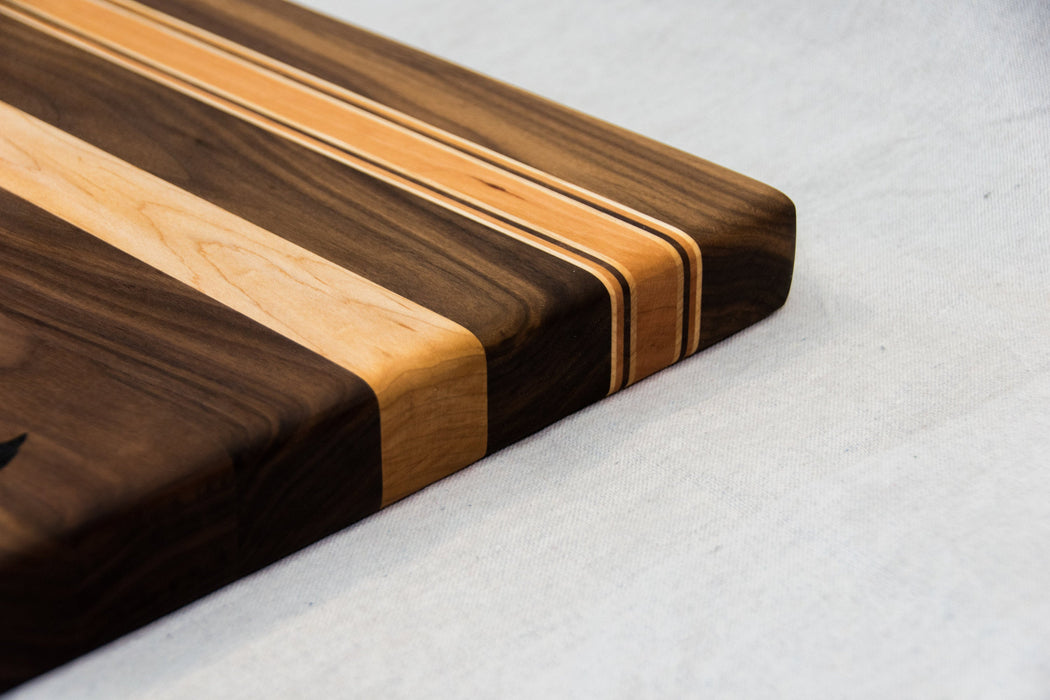 Walnut with stripes of Maple and Cherry Cutting Board