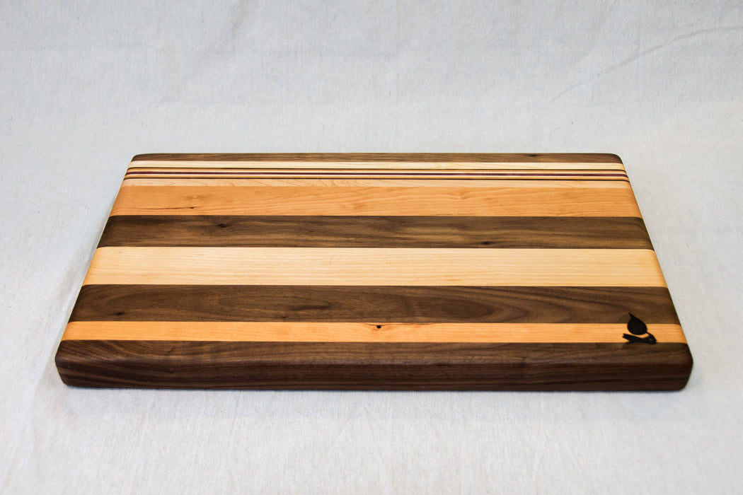 Walnut with stripes of Maple, Cherry and Purple Heart Cutting Board