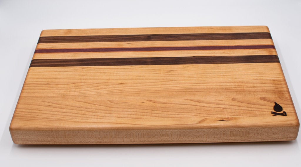 Maple with stripes of Walnut, Cherry, and Purple Heart Cutting Board